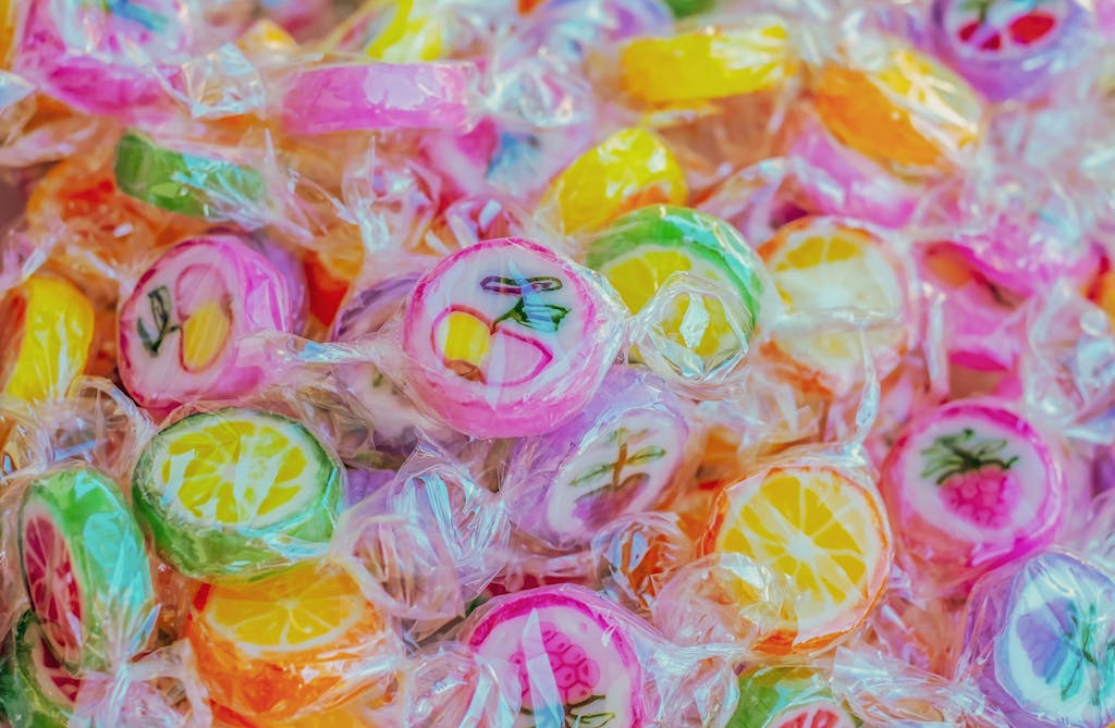 Vibrant close-up of colorful fruit-shaped candies, highlighting texture and sweetness.